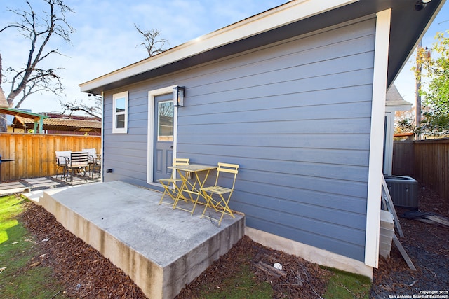 rear view of property with a patio and central air condition unit