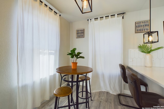 dining space featuring wood-type flooring and a barn door
