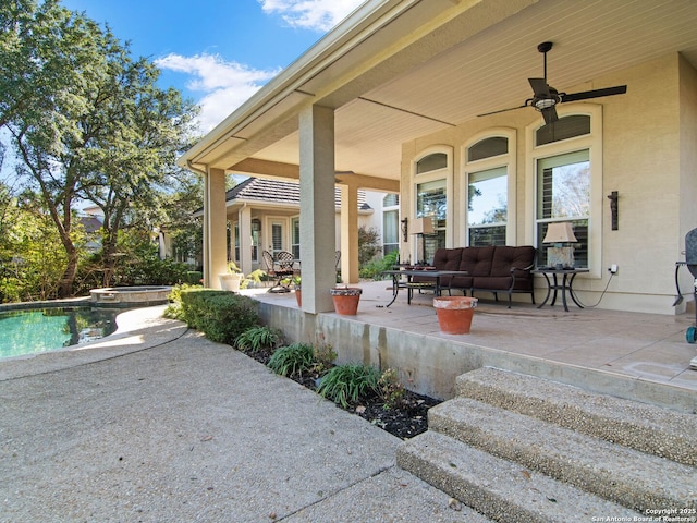 view of patio / terrace with an outdoor living space, a swimming pool with hot tub, and ceiling fan