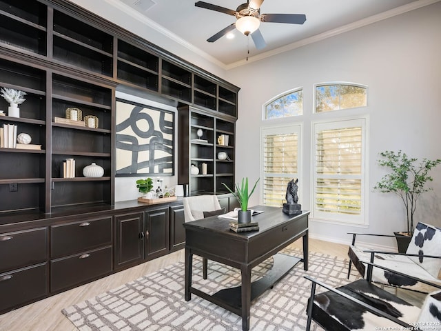 home office with ceiling fan, ornamental molding, and light wood-type flooring