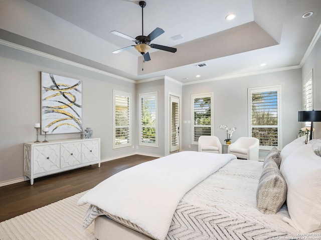 bedroom with crown molding, ceiling fan, dark hardwood / wood-style flooring, and a raised ceiling