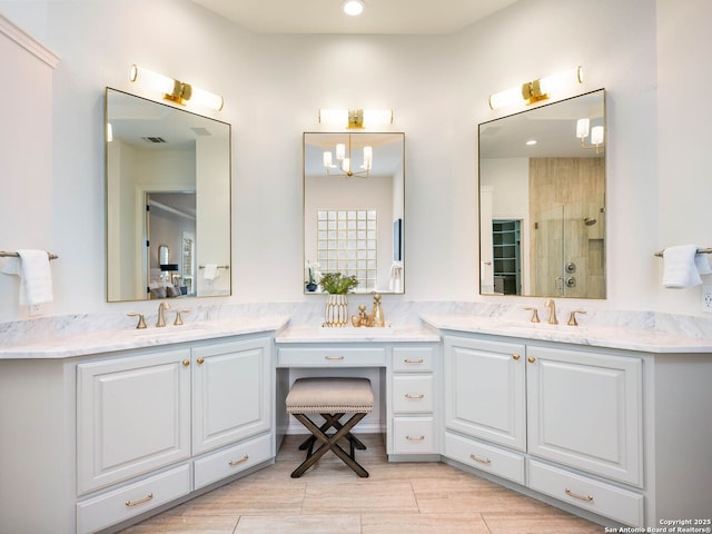 bathroom featuring vanity and a shower with door