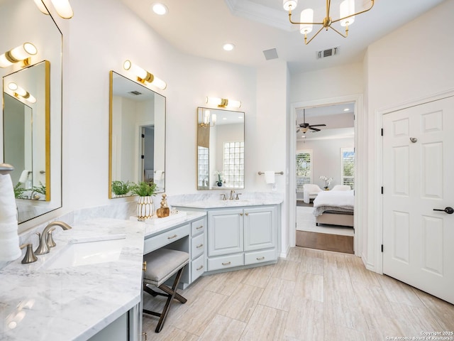 bathroom with vanity and ceiling fan with notable chandelier