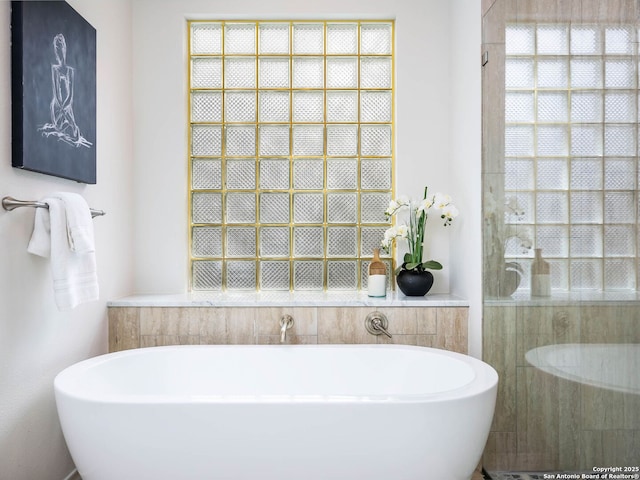 bathroom featuring separate shower and tub