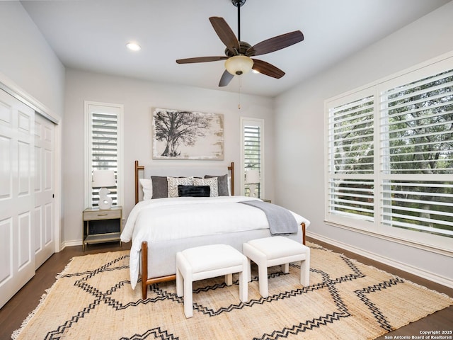 bedroom featuring ceiling fan, dark hardwood / wood-style flooring, and a closet