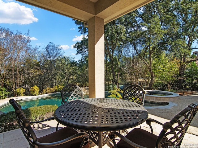 view of patio featuring a swimming pool with hot tub