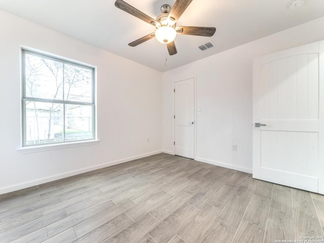 spare room with ceiling fan and light hardwood / wood-style flooring