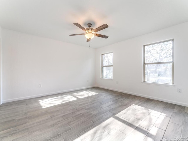 spare room with light hardwood / wood-style flooring and ceiling fan