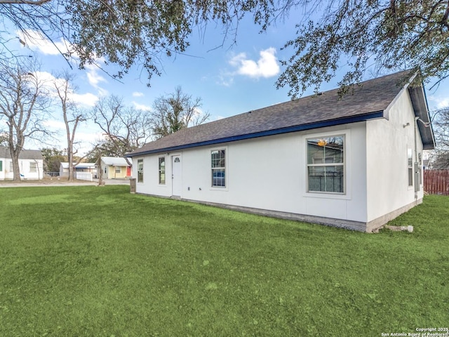 rear view of property with a yard