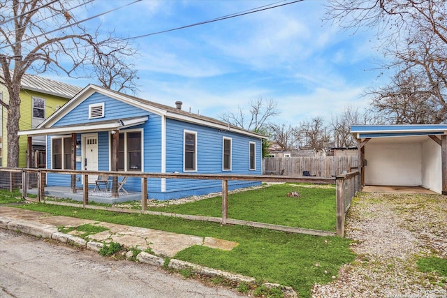 view of home's exterior featuring a porch and a yard