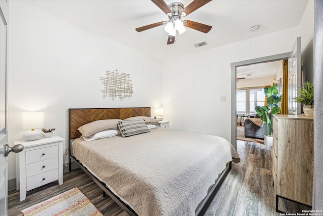 bedroom with dark hardwood / wood-style floors and ceiling fan