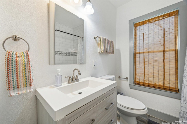 bathroom featuring vanity, a shower with curtain, and toilet