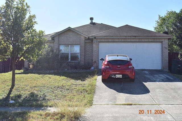 ranch-style house with a garage and a front lawn