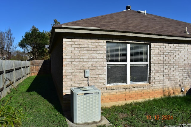 view of property exterior featuring a yard and central AC unit