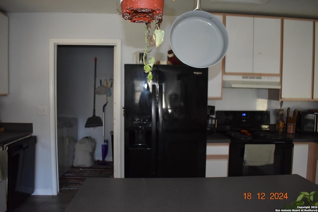 kitchen featuring white cabinetry and black appliances