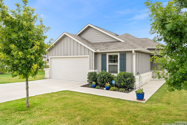 view of front of home with a garage and a front yard