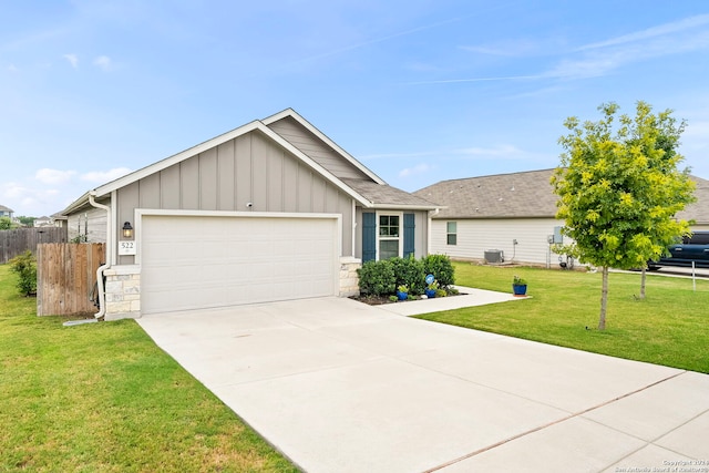 ranch-style house featuring cooling unit, a garage, and a front lawn