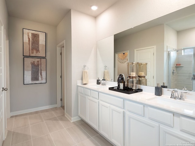 bathroom with vanity, a shower with shower door, and tile patterned floors