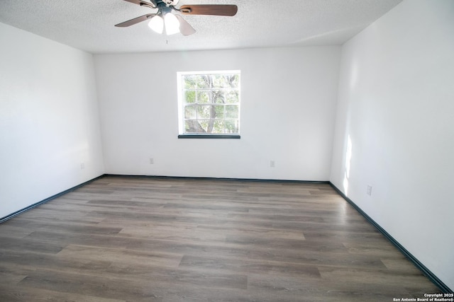 empty room with ceiling fan, dark hardwood / wood-style floors, and a textured ceiling