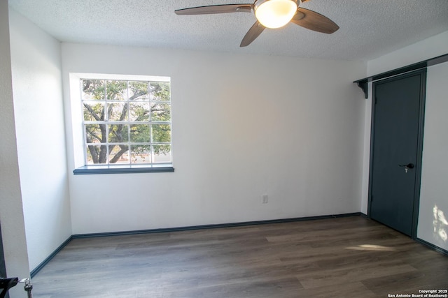 unfurnished bedroom featuring ceiling fan, a closet, dark hardwood / wood-style floors, and a textured ceiling