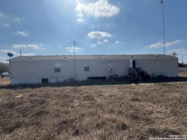 rear view of house featuring cooling unit