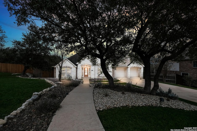 single story home with a garage and a yard