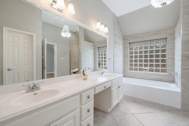 bathroom featuring tile patterned flooring, a bathing tub, and vanity