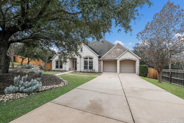 view of front of home with a garage and a front yard