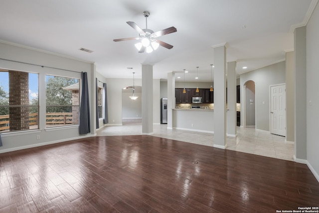 unfurnished living room featuring light hardwood / wood-style flooring, ornamental molding, and ceiling fan