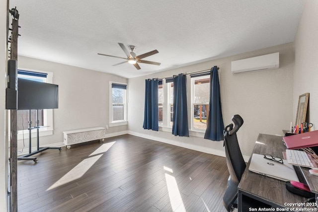 office area with dark wood-type flooring, a textured ceiling, an AC wall unit, radiator, and ceiling fan