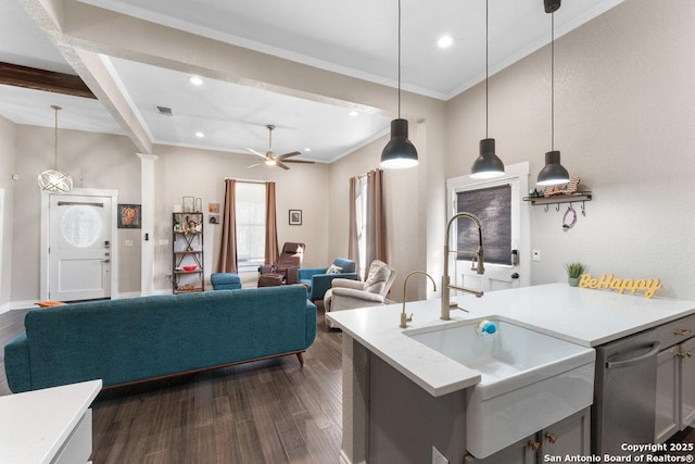 kitchen featuring sink, dark wood-type flooring, ceiling fan, hanging light fixtures, and ornamental molding