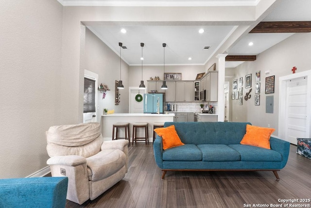 living room featuring beam ceiling, decorative columns, electric panel, ornamental molding, and dark hardwood / wood-style flooring