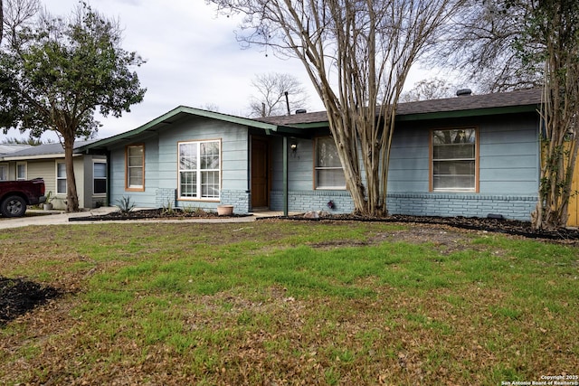 single story home featuring brick siding and a front lawn