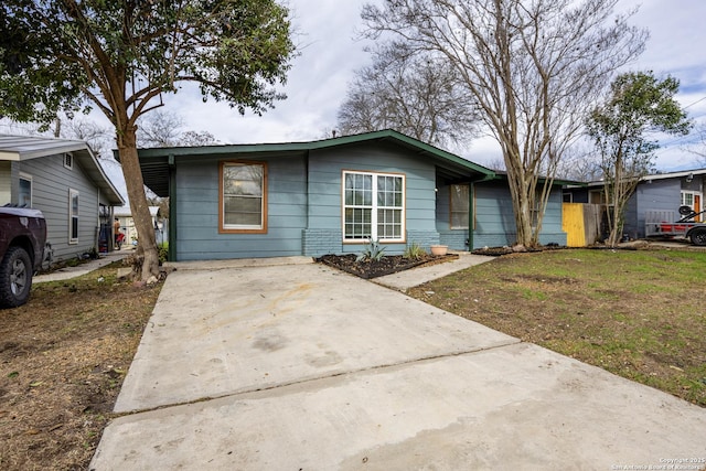 view of front of property featuring brick siding and driveway