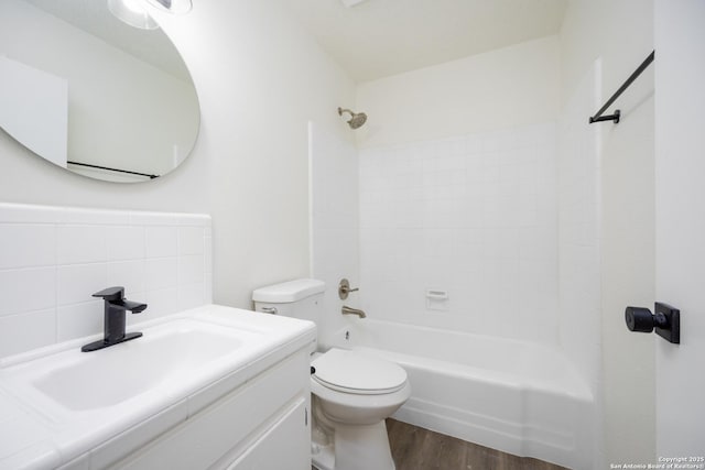 full bathroom with tub / shower combination, toilet, vanity, and wood finished floors