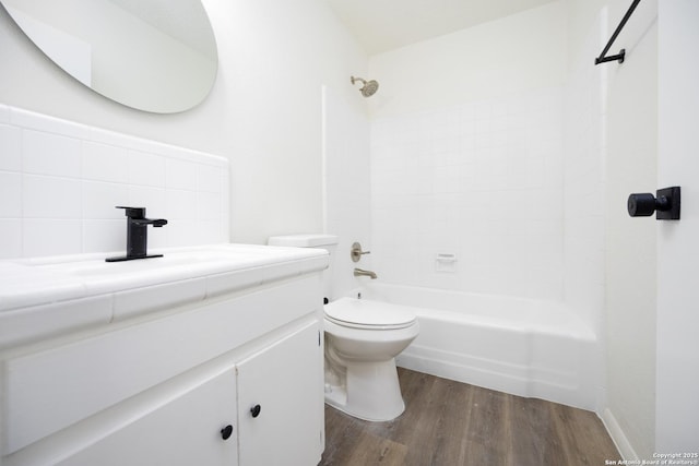 full bath with vanity, toilet, wood finished floors, and  shower combination