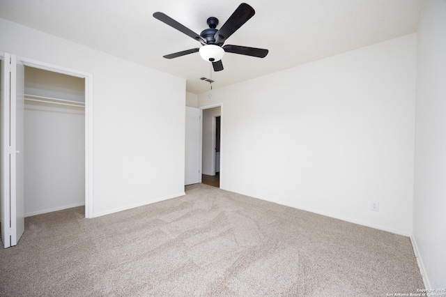 unfurnished bedroom with visible vents, a closet, carpet floors, baseboards, and ceiling fan