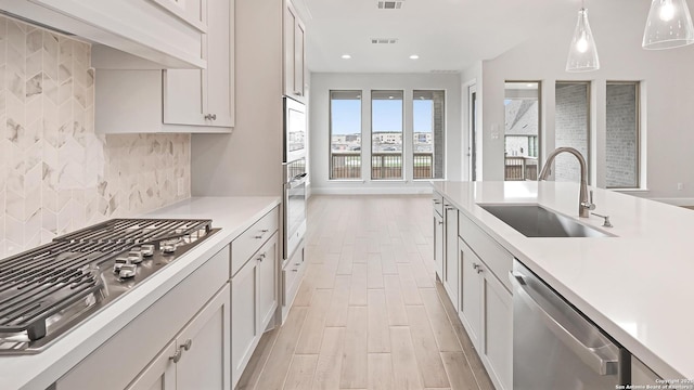 305 Hulda Trl, New Braunfels, TX 78130 - kitchen with stainless steel appliances, a sink, light countertops, backsplash, and recessed lighting