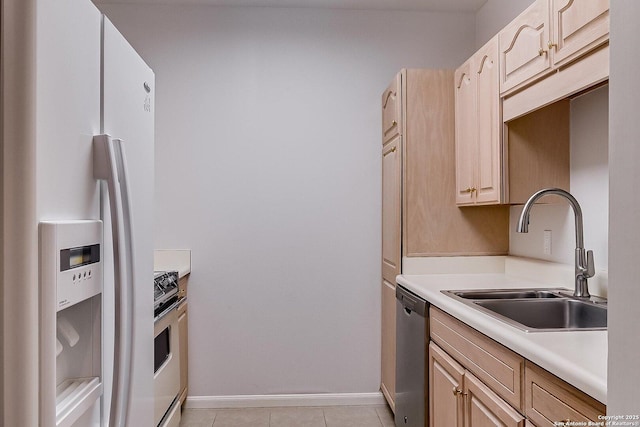 kitchen featuring sink, white refrigerator with ice dispenser, dishwasher, and light brown cabinets