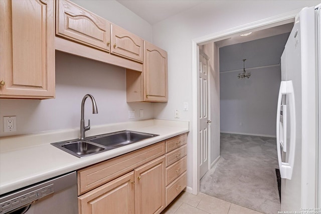 kitchen with white refrigerator, dishwasher, sink, and light brown cabinets