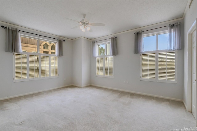 carpeted spare room featuring ceiling fan and a textured ceiling