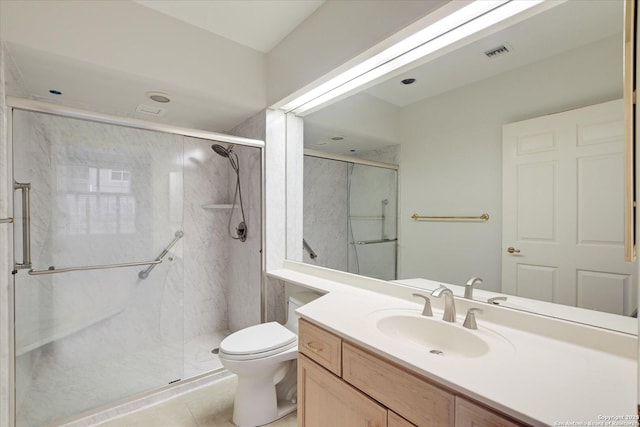 bathroom featuring vanity, tile patterned floors, a shower with door, and toilet