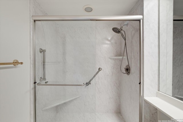 bathroom with a shower with shower door