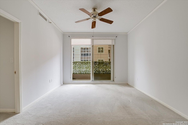 empty room featuring light colored carpet, ornamental molding, and a textured ceiling