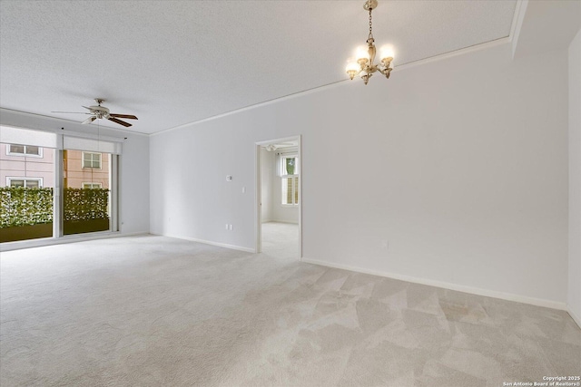 unfurnished room with crown molding, ceiling fan with notable chandelier, light colored carpet, and a textured ceiling