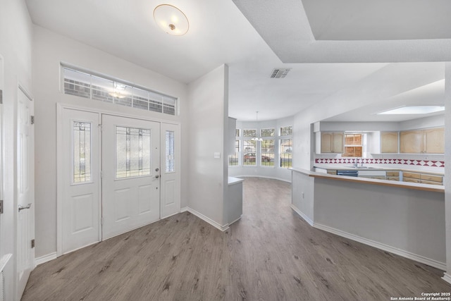 entryway with sink and light wood-type flooring