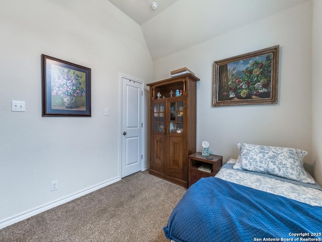 carpeted bedroom featuring vaulted ceiling