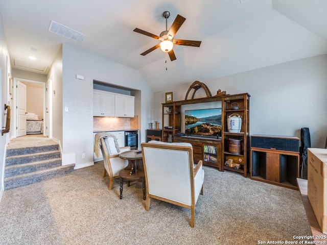 living room with wine cooler, ceiling fan, lofted ceiling, and light carpet