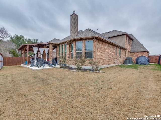 back of house featuring a yard, a patio area, and central air condition unit