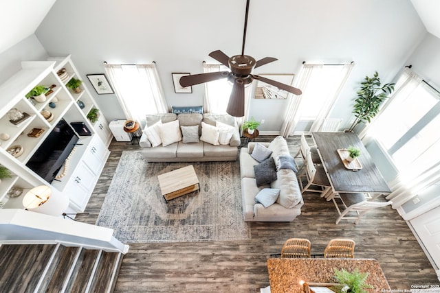 living room featuring ceiling fan, dark hardwood / wood-style floors, and high vaulted ceiling